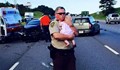 Полицай утешава бебе след тежка катастрофа