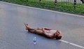 Чисто гол мъж легна по средата на оживен булевард