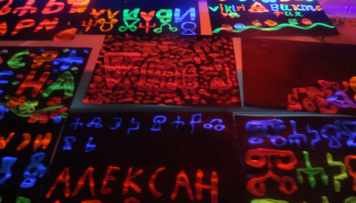 Миналото на буквите срещна бъдещето, когато децата поставиха своите изрисувани неонови имена под UV светлината