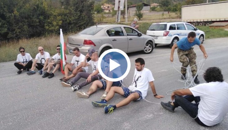 В момента протестиращите скандират "Българи юнаци", седнали край международния път