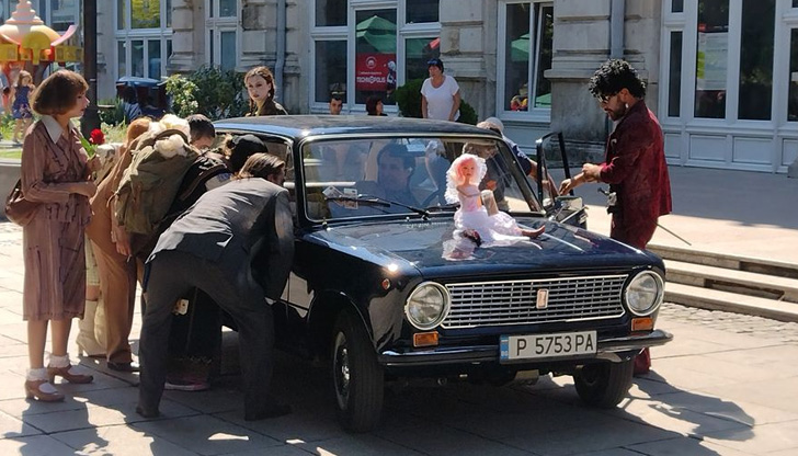 Около колата се струпаха хора, облечени с дрехи от времето