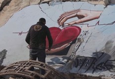Ярко червено сърце контрастира със сивите руини наоколоДвама сирийски художници