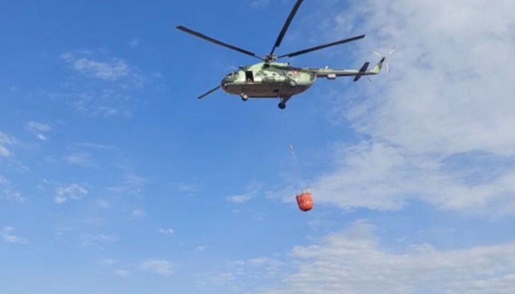 Хеликоптер от авиобазата гази от въздуха с вода